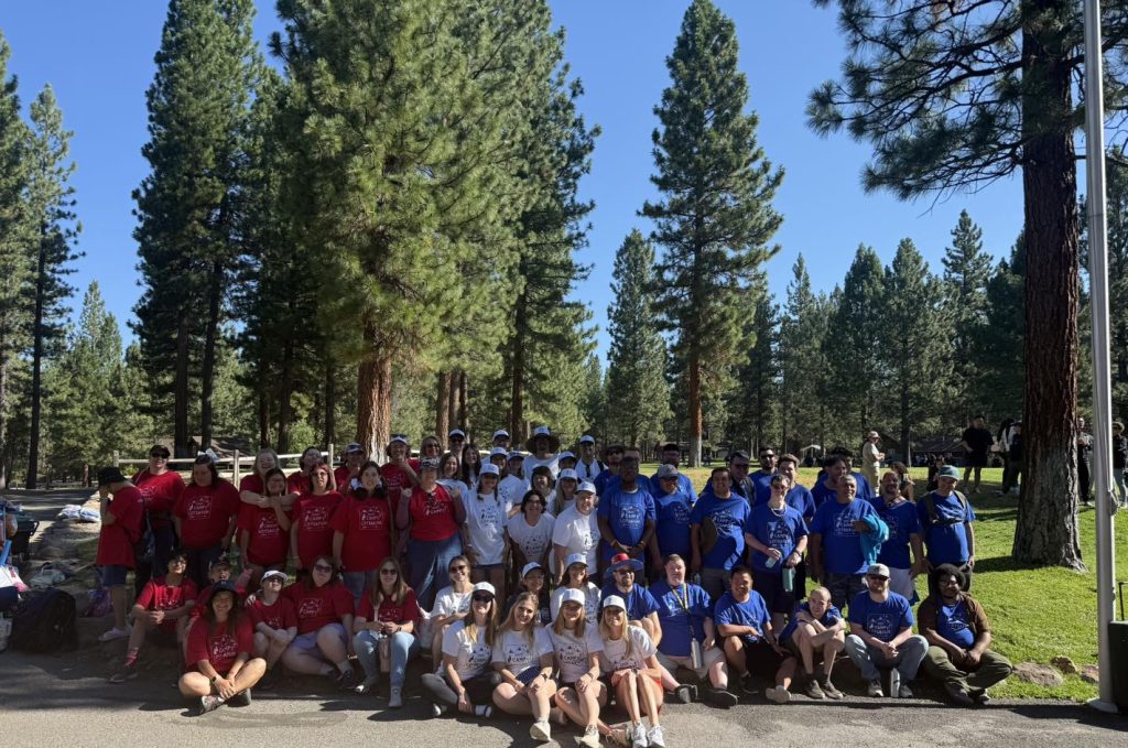 Camp Lotsafun campers and volunteers in colorful team shirts at camp
