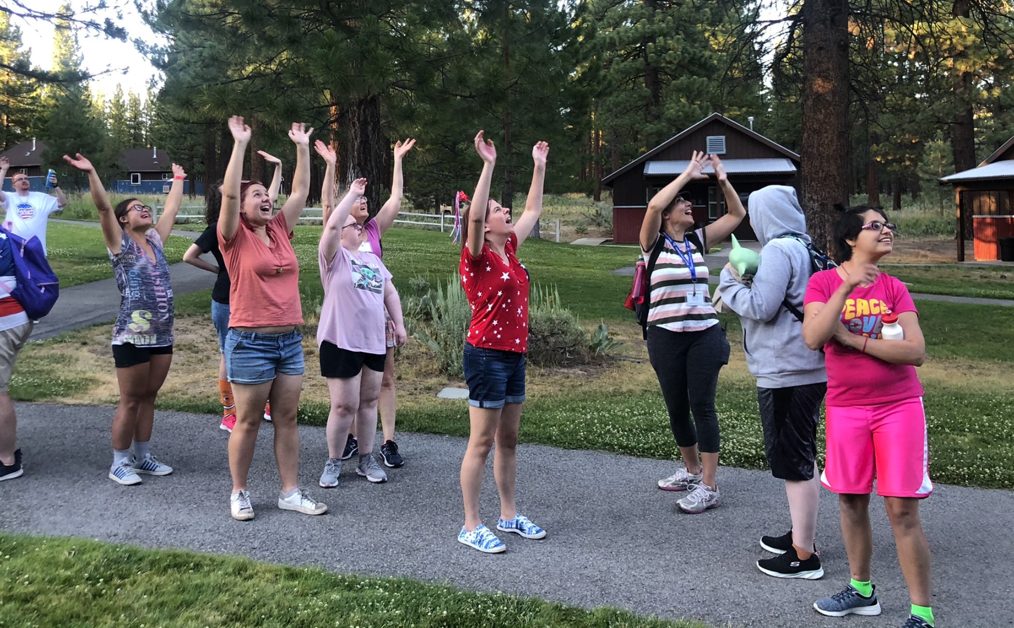 Campers cheering outside a cabin