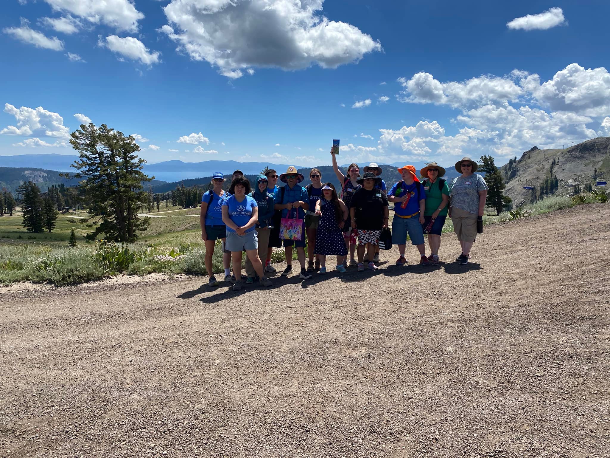 Group hike under a wide mountain sky