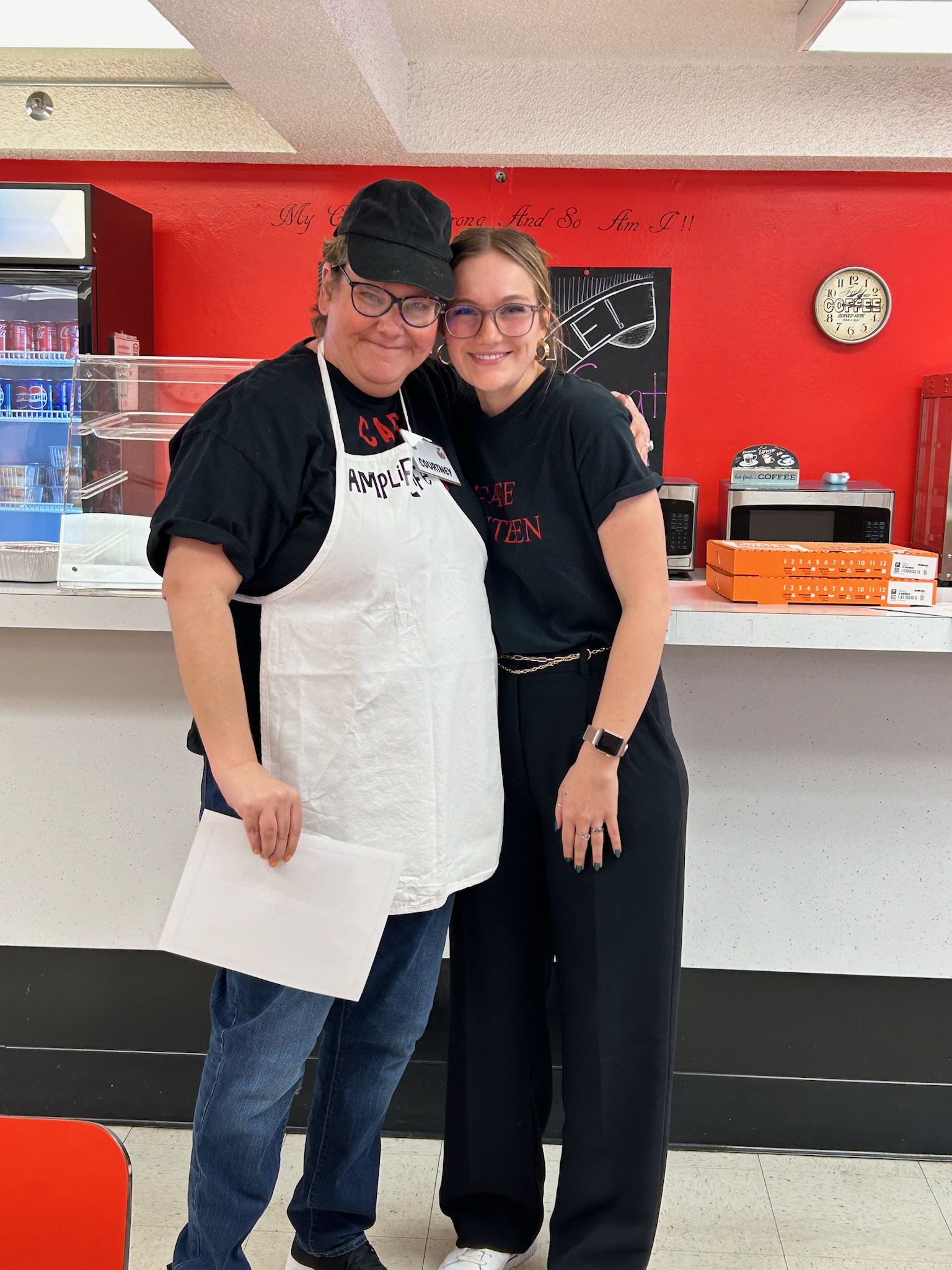 Staff member and participant wearing aprons