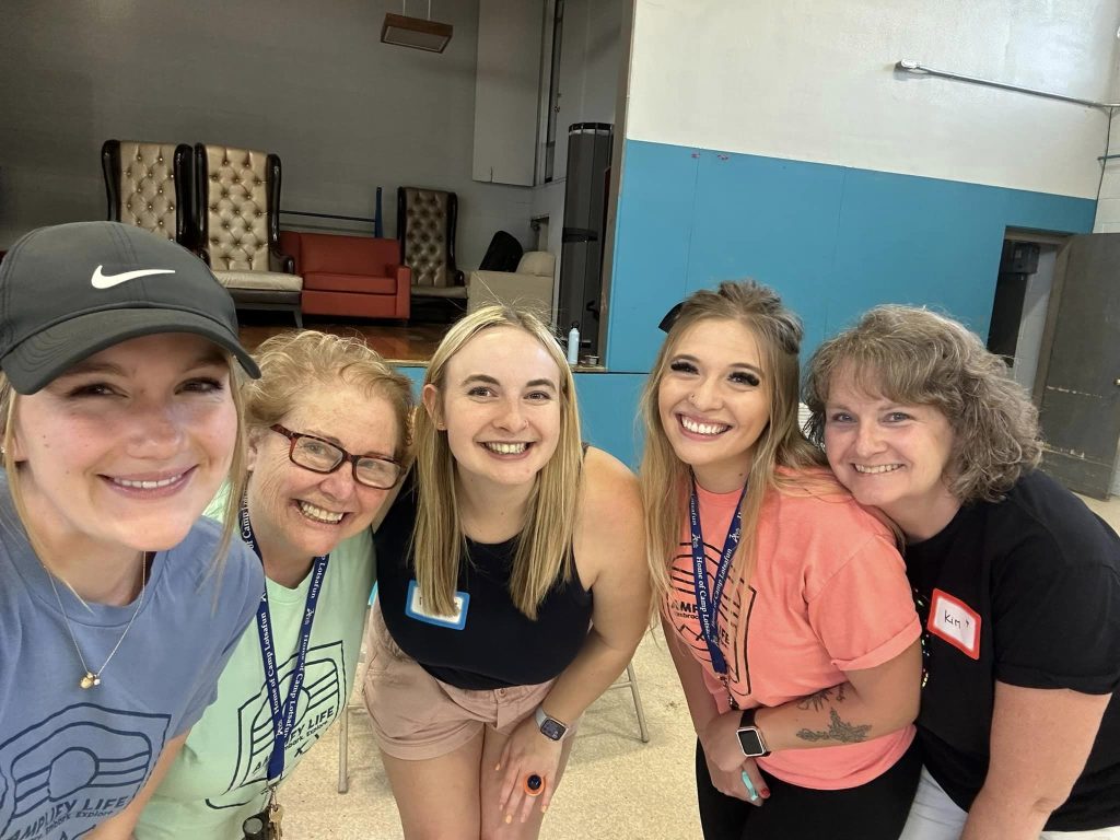Smiling group selfie of Amplify Life volunteers and participants