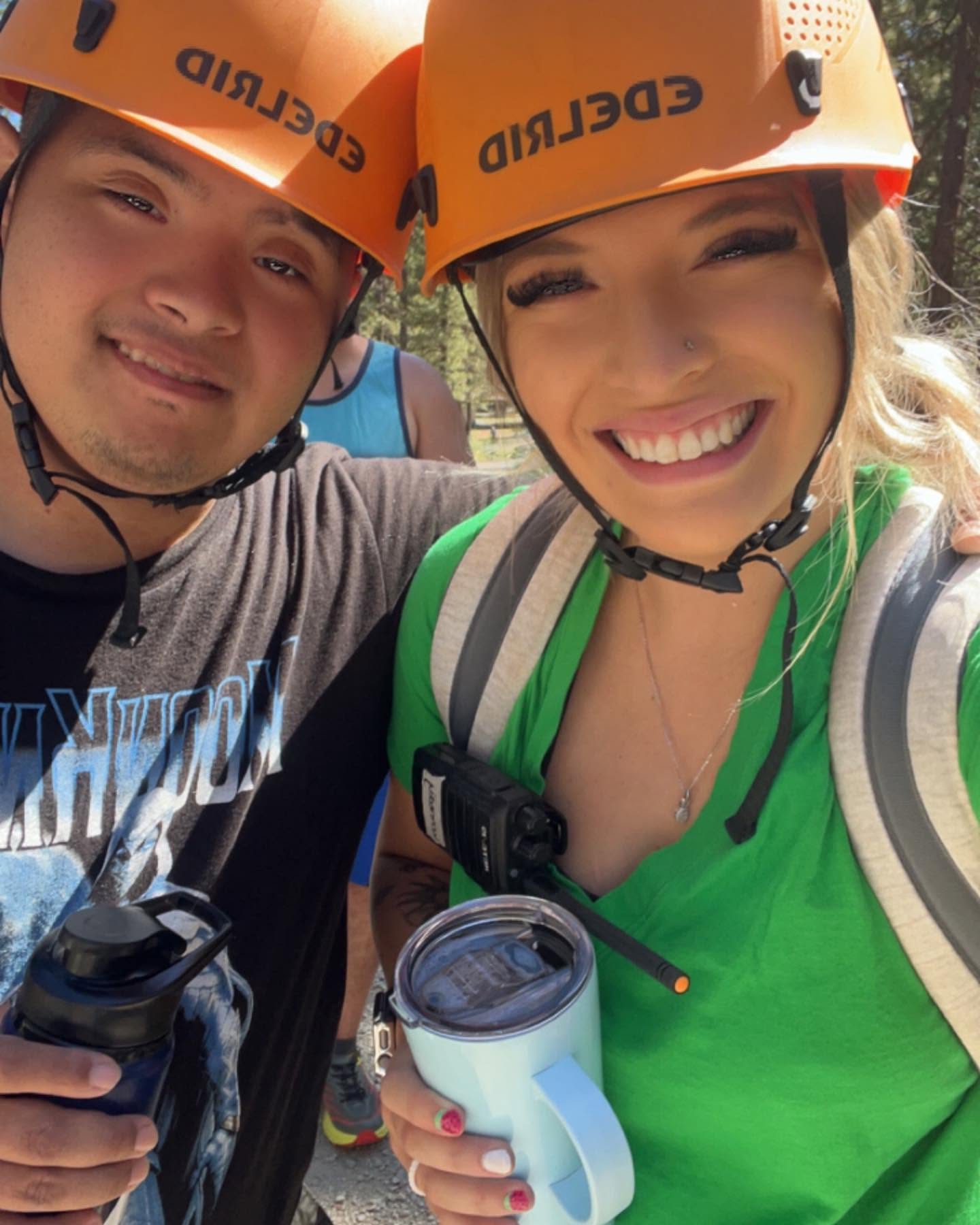 Staff member and participant in climbing helmets