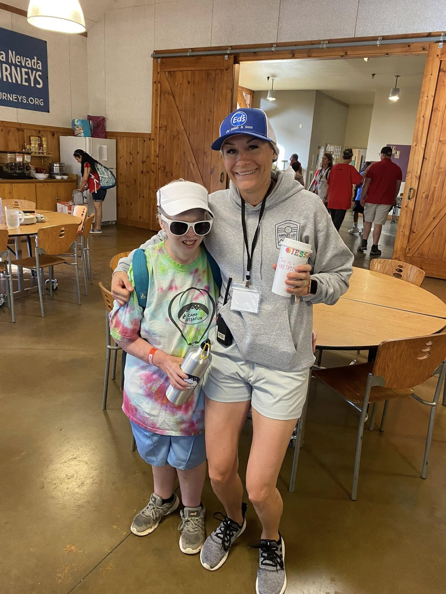 Staff member hugging a camper at Camp Lotsafun
