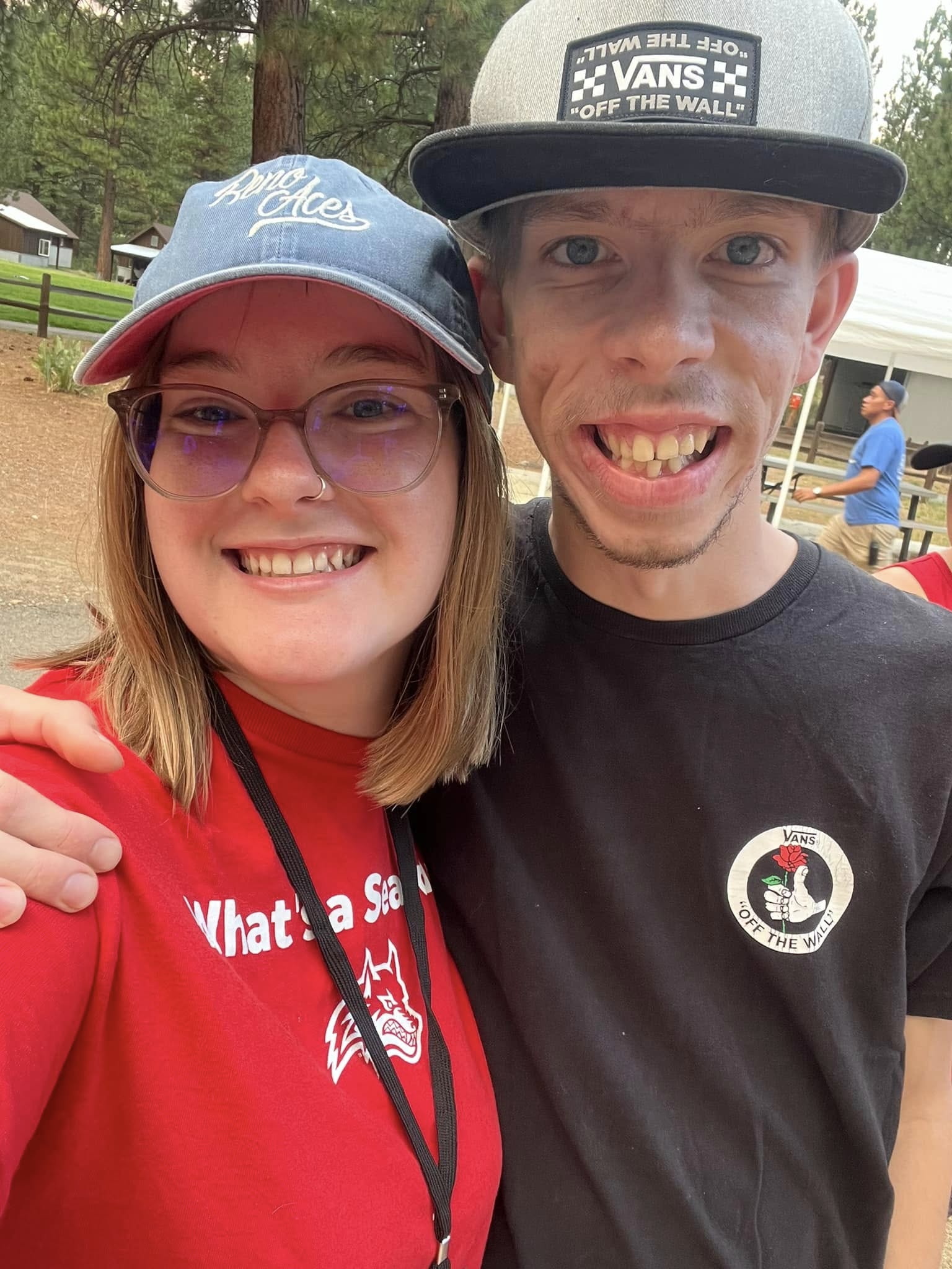 Staff member smiling with a participant at camp