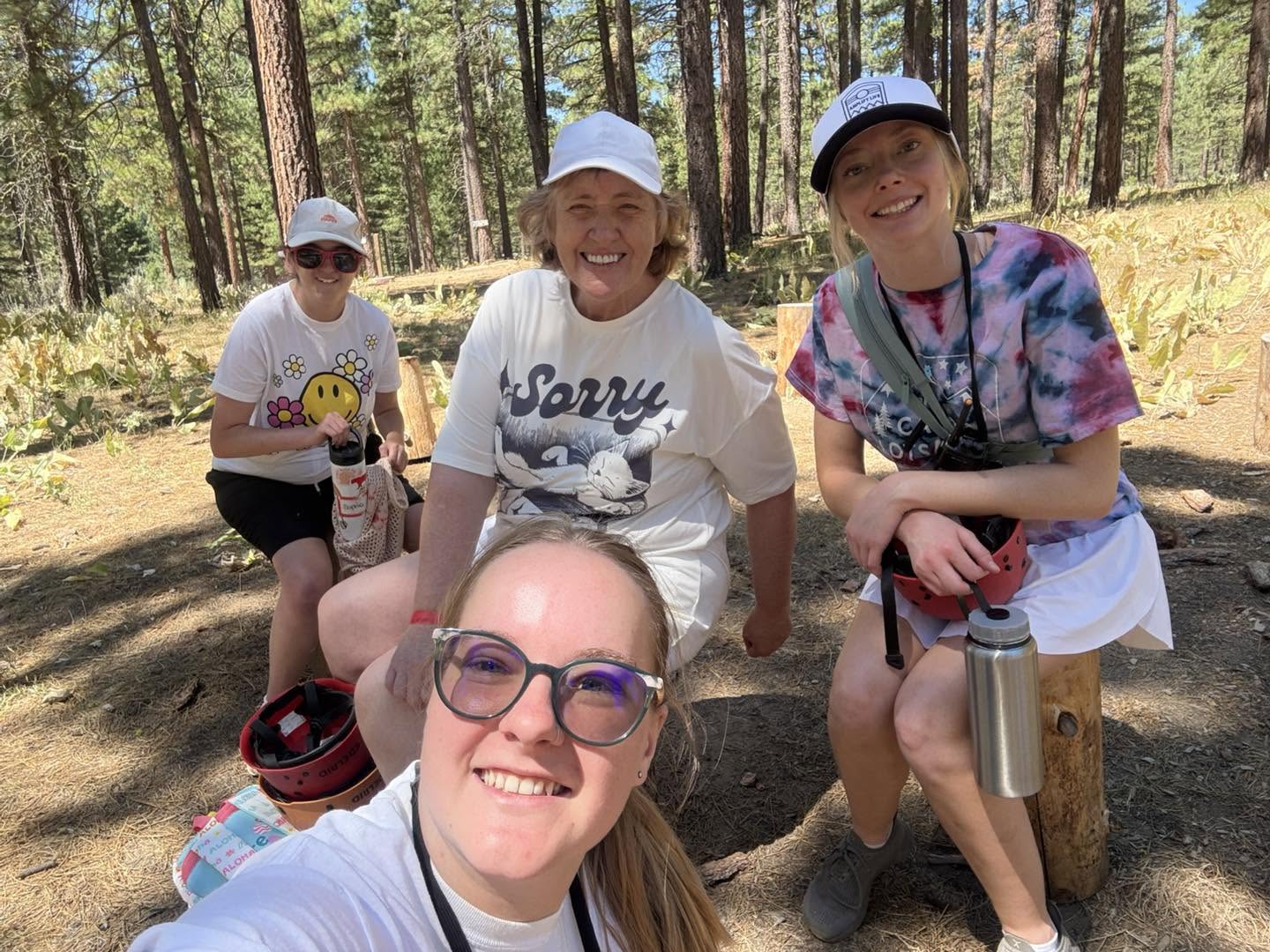 Staff and campers resting in the forest at camp