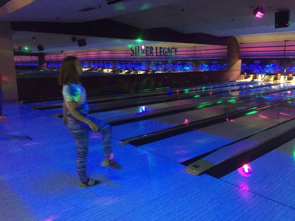 Participant bowling under blacklights