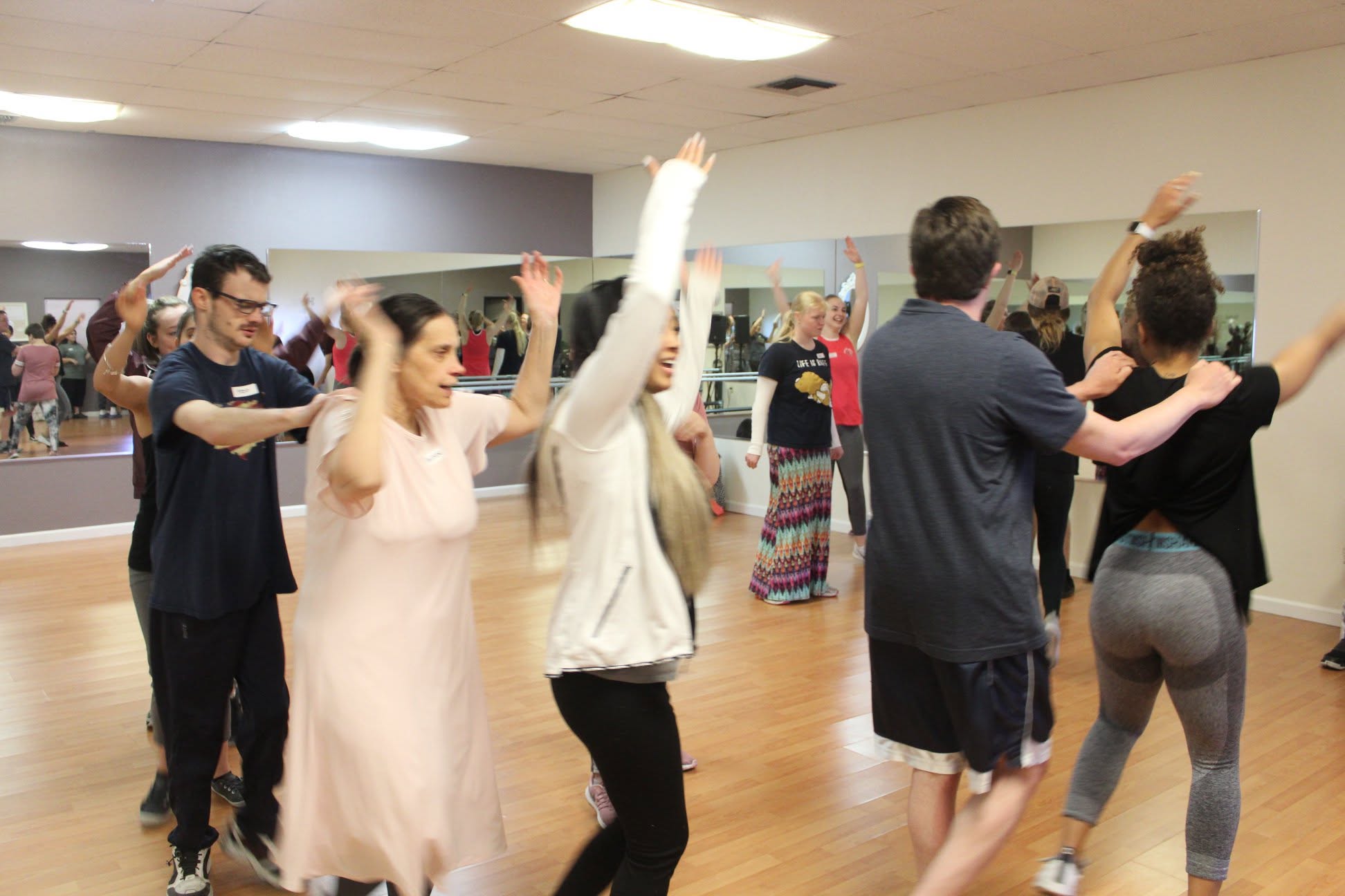 Participants dancing with partners in class