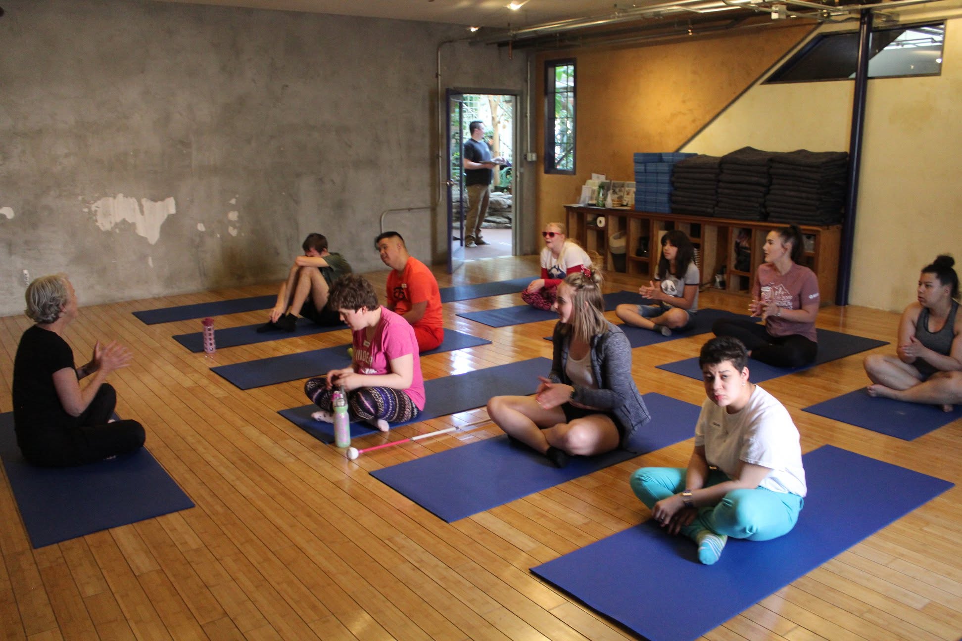 Participants on yoga mats at a yoga and meditation class